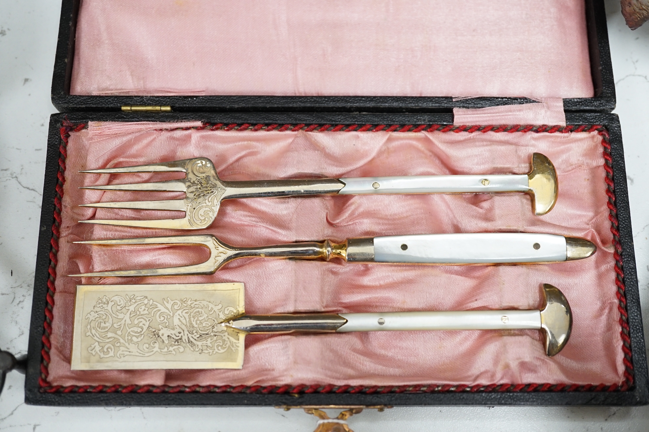 Three plated trays, a cased three piece mother of pearl handled cutlery set, etc.